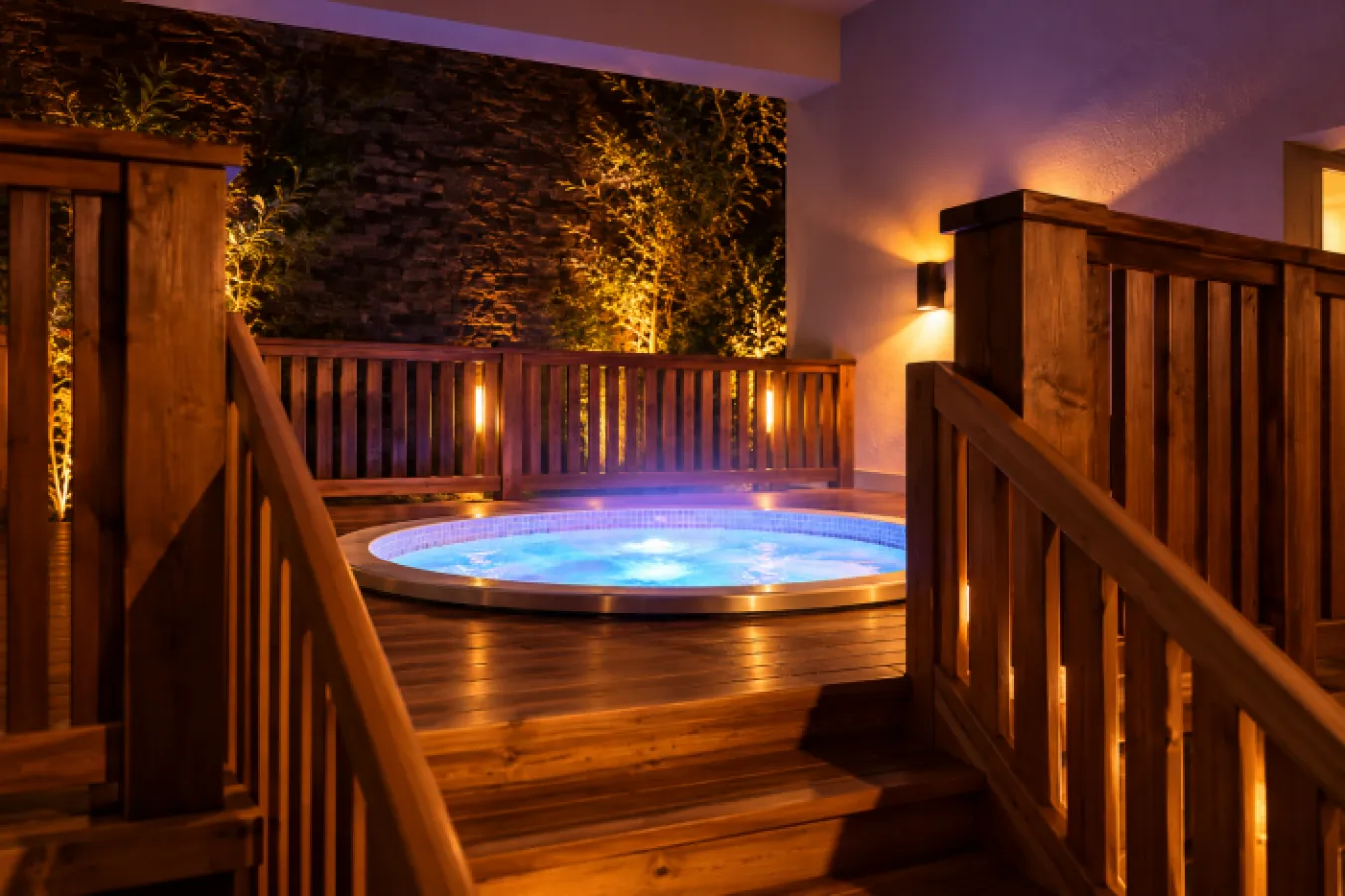 A hot tub on a wooden deck in front of a painting of castle ruins