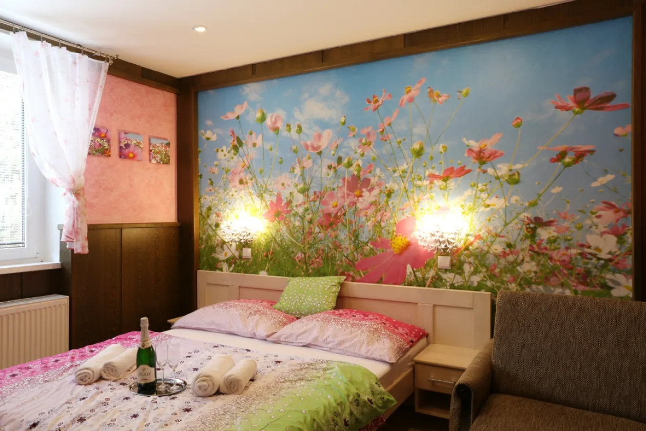 A double room in the guest house with a double bed and seating by the window